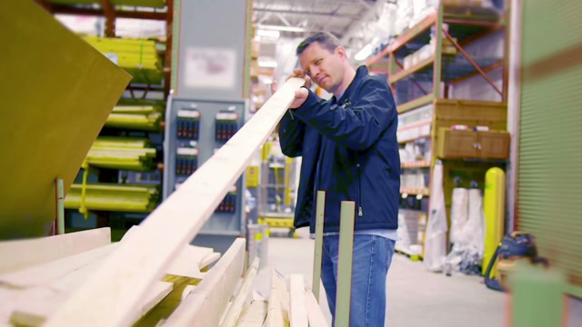 a man picks out lumber at a big box hardware store srqedvr8 1080 d thumbnail 360 05